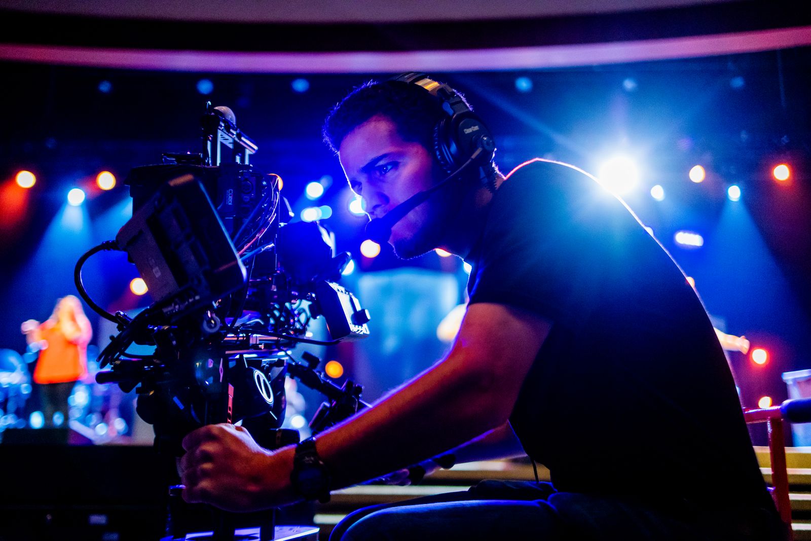 Camera operator working under stage lighting